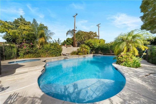 view of swimming pool featuring an in ground hot tub and a patio area