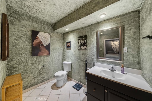 bathroom featuring tile patterned flooring, vanity, and toilet