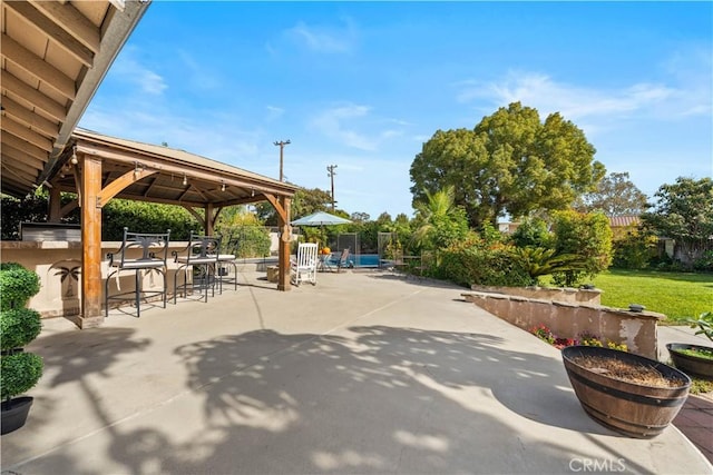 view of patio / terrace with a gazebo and an outdoor bar