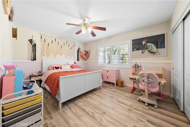 bedroom featuring ceiling fan, a closet, and light wood-type flooring