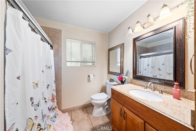 bathroom featuring tile patterned flooring, vanity, toilet, and walk in shower