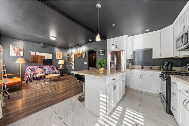 kitchen featuring white cabinets, a center island, and stainless steel appliances