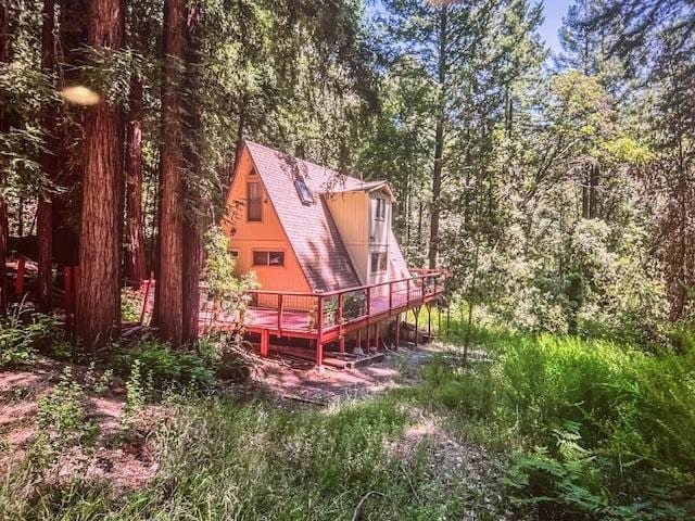 back of property featuring a wooden deck