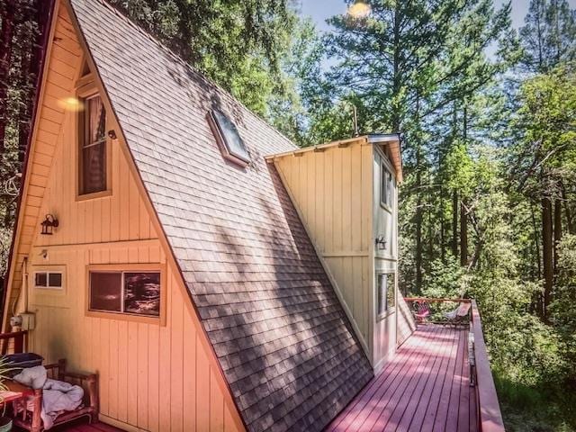 view of side of home with a wooden deck