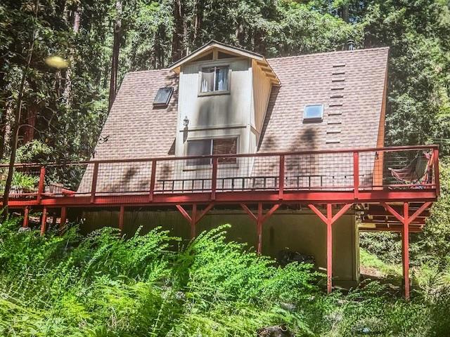 rear view of property with a wooden deck