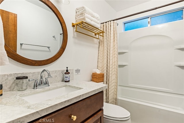 full bathroom featuring toilet, vanity, and shower / tub combo