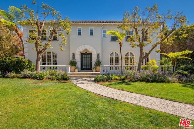 mediterranean / spanish home featuring a front yard