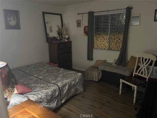 bedroom with dark hardwood / wood-style flooring