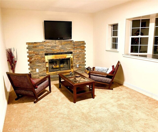 carpeted living room with a fireplace