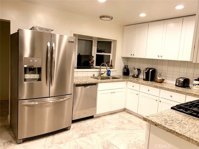 kitchen with white cabinets, appliances with stainless steel finishes, and sink