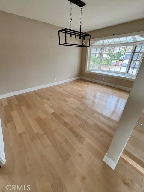 unfurnished dining area featuring light wood-type flooring