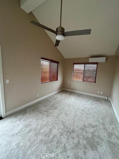 carpeted spare room with a wall mounted air conditioner, ceiling fan, and lofted ceiling