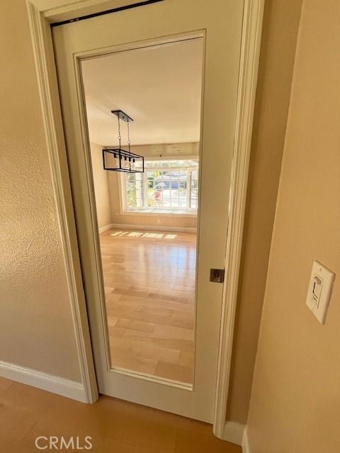 interior details with a chandelier and wood-type flooring