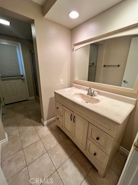 bathroom featuring tile patterned flooring and vanity