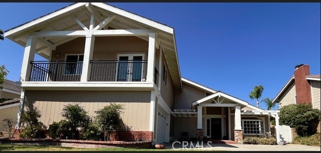 view of front of house featuring a balcony and a garage