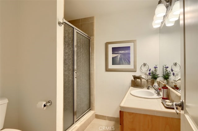 bathroom featuring vanity, toilet, tile patterned floors, and an enclosed shower