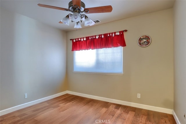 spare room featuring wood-type flooring and ceiling fan