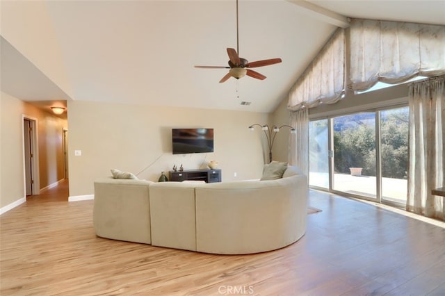 living room with light hardwood / wood-style floors, high vaulted ceiling, and ceiling fan