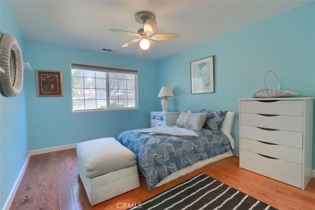 bedroom with ceiling fan and hardwood / wood-style floors