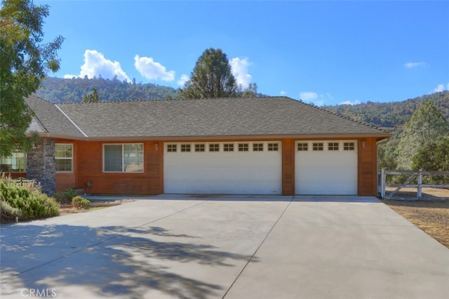 ranch-style home with a mountain view and a garage