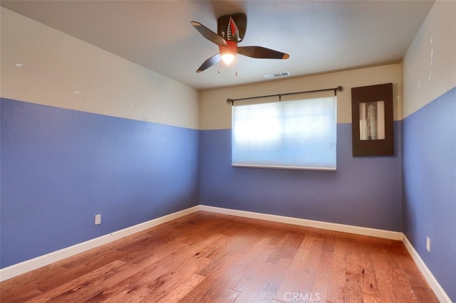 spare room featuring light hardwood / wood-style flooring and ceiling fan