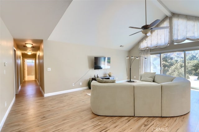 living room with ceiling fan, light hardwood / wood-style flooring, and vaulted ceiling with beams