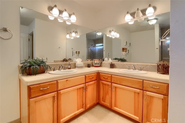 bathroom with vanity, an enclosed shower, and tile patterned flooring