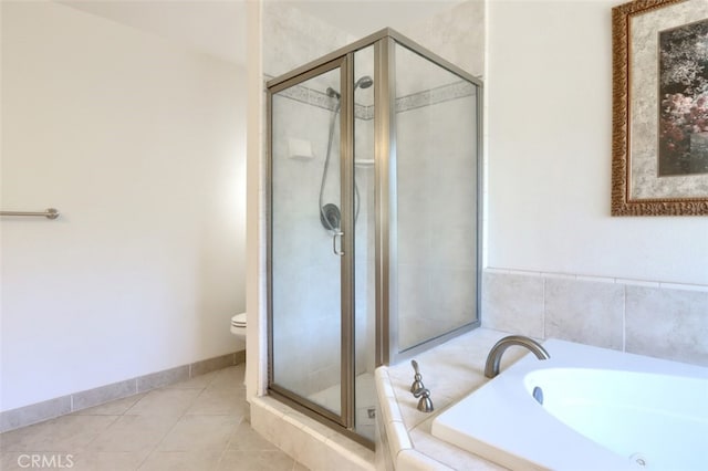 bathroom featuring tile patterned floors, shower with separate bathtub, and toilet