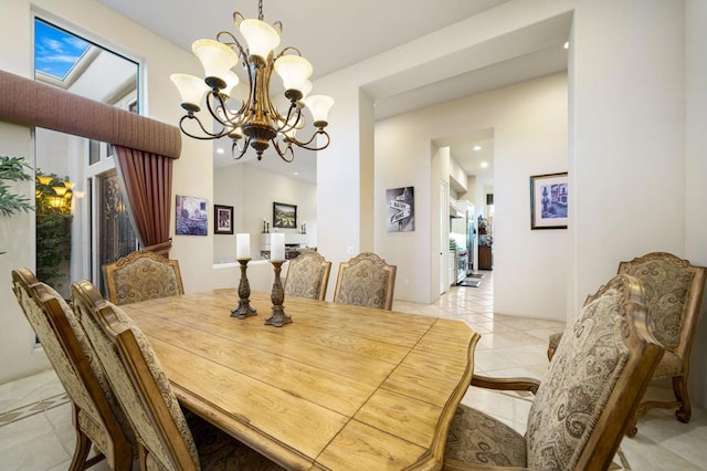 tiled dining space featuring a chandelier