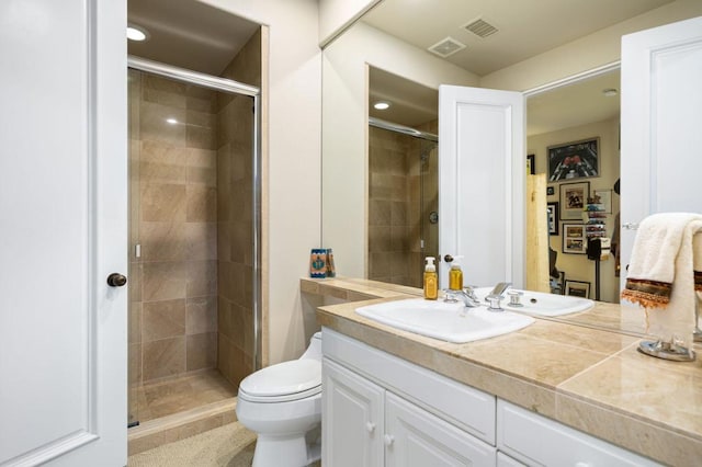 bathroom featuring vanity, an enclosed shower, and toilet