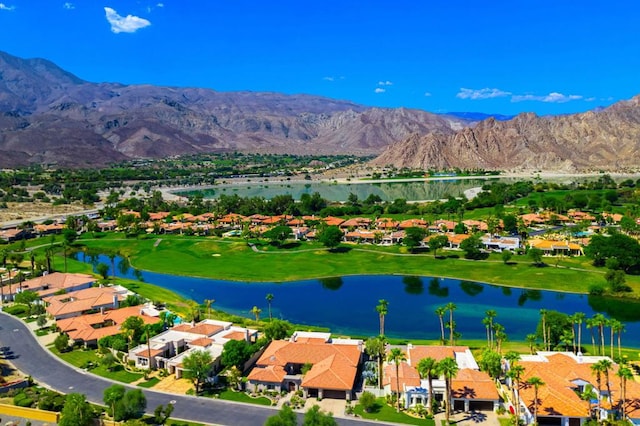 drone / aerial view with a water and mountain view