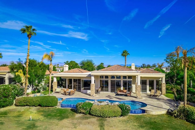 rear view of property featuring an outdoor living space and a patio