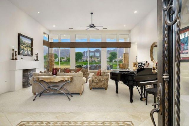 living room with ceiling fan and light tile patterned floors