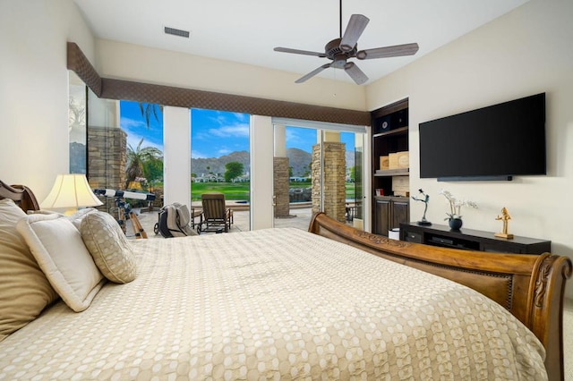 bedroom with ceiling fan and multiple windows