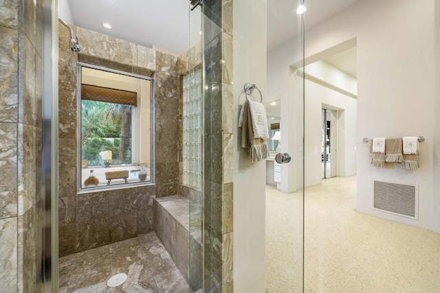 bathroom with a tile shower