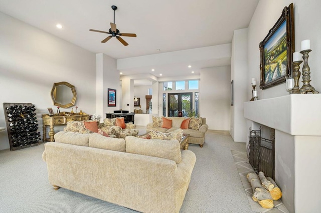 carpeted living room with ceiling fan