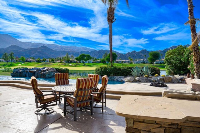 view of patio featuring a water and mountain view