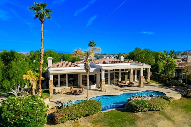 back of property featuring an outdoor hangout area and a patio