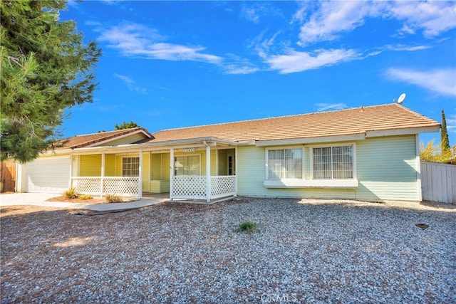 ranch-style home with covered porch and a garage