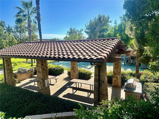 view of property's community with area for grilling and a patio area