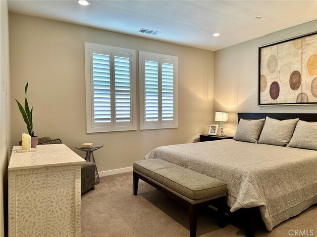 bedroom with light colored carpet