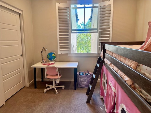 bedroom featuring carpet and baseboards