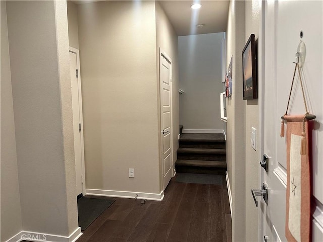 hall featuring dark wood-style floors and baseboards