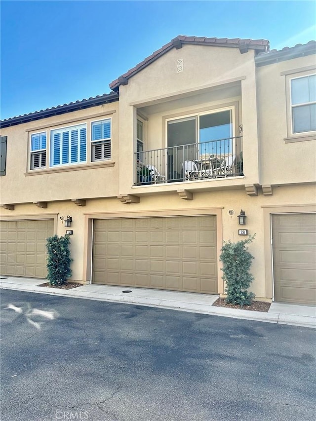 view of property with an attached garage and stucco siding