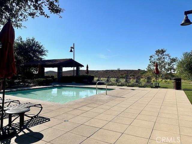 view of swimming pool featuring a gazebo and a patio