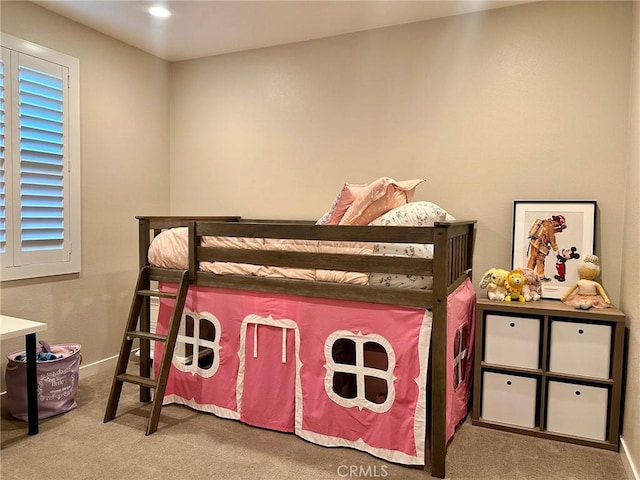 bedroom featuring carpet and baseboards