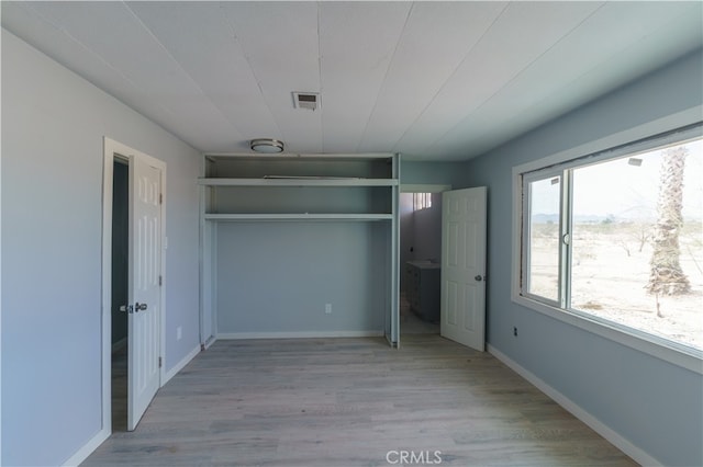 unfurnished bedroom with light wood-type flooring