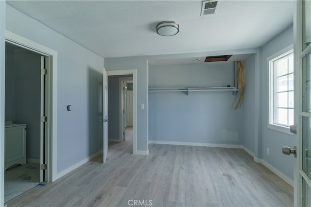 unfurnished bedroom with a closet and light hardwood / wood-style flooring