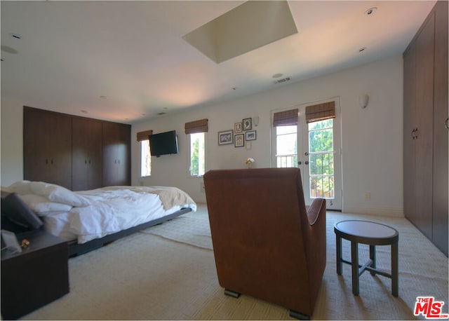 carpeted bedroom with access to exterior and french doors