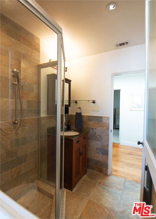 bathroom with vanity, wood-type flooring, and an enclosed shower